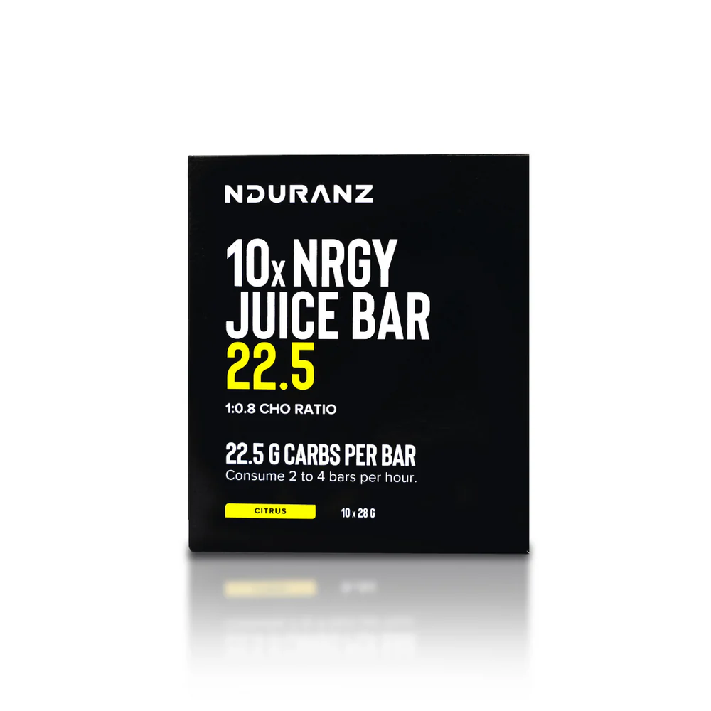 Nduranz Energy Juice Bar 22.5 with vibrant fruit and nut toppings on a white plate, showcasing a nutritious snack.