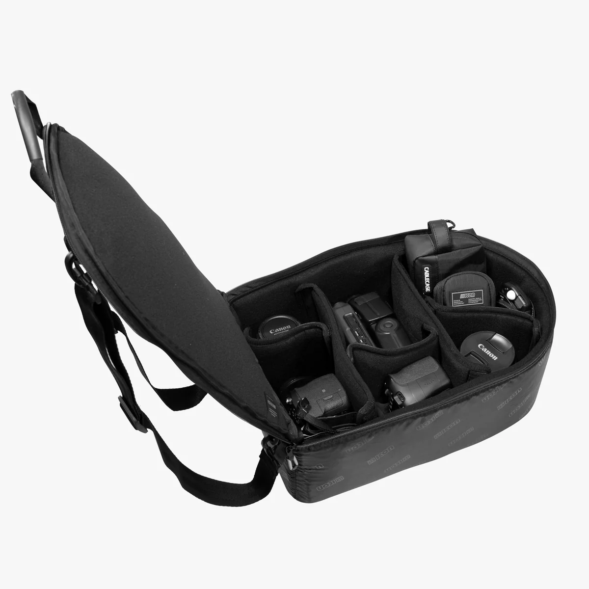 Scicon camera organizer insert inside a 35L backpack, with padded compartments for camera gear and accessories.